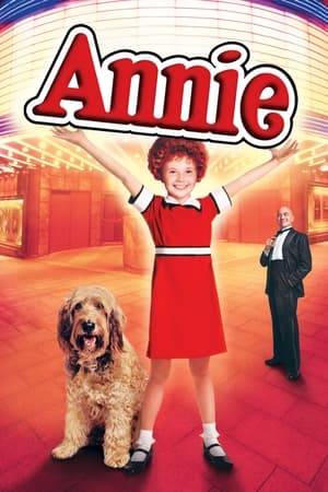 An orphan in a facility run by the mean Miss Hannigan, Annie believes that her parents left her there by mistake. When a rich man named Oliver "Daddy" Warbucks decides to let an orphan live at his home to promote his image, Annie is selected. While Annie gets accustomed to living in Warbucks' mansion, she still longs to meet her parents. So Warbucks announces a search for them and a reward, which brings out many frauds.