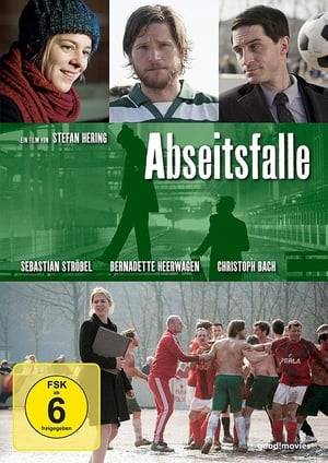 ABSEITSFALLE is the story of Karin and Mike. They work at Perla, a washing machine manufacturer. She is a career woman, he is on the assembly line and plays for the factory soccer team. The company is owned by an American corporation. Until now it has been business as usual, but all of a sudden comes the news that 400 redundancies are needed if Perla is to survive. Suddenly, there is everything to play for. Written by Anonymous